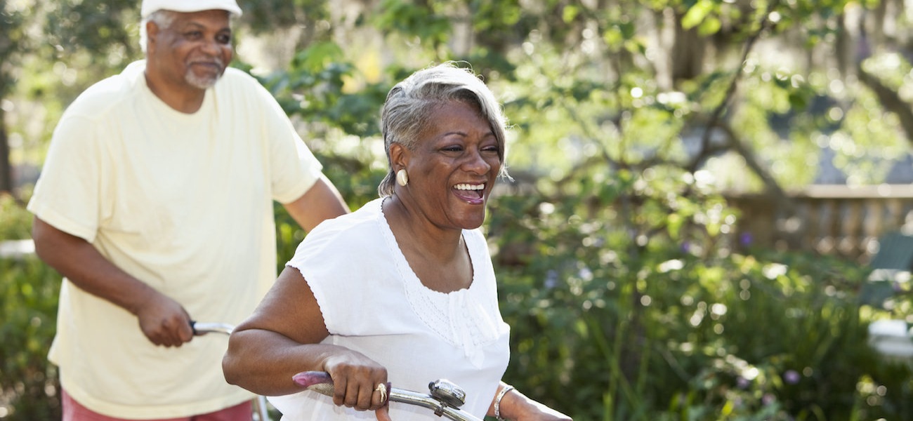 Homepage rotator with senior couple riding bikes together in a park